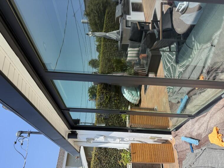 Clean sliding glass door with backyard patio visible